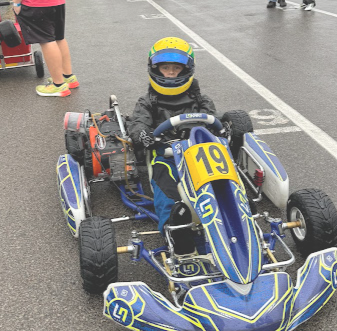 A Kid Sits on Grid in His Lando Norris Kart with a Lawson Speed Shop LO206 Motor.